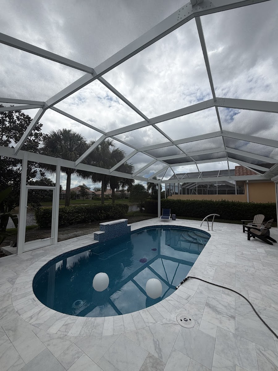 Pool cage screen enclosure over a backyard pool